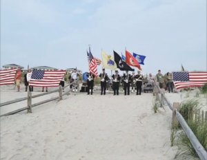 people on the beach with american flags